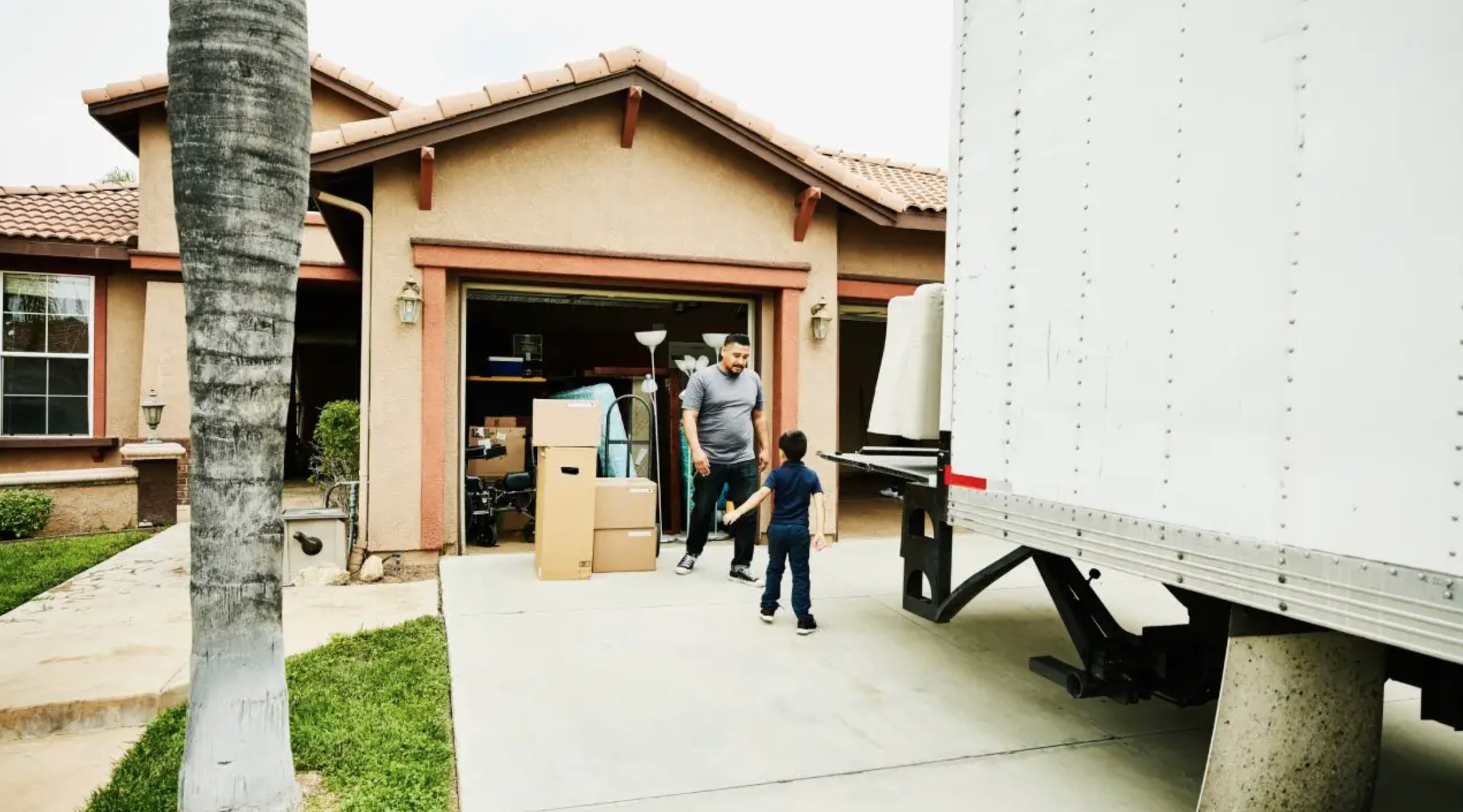New homeowners unloading moving boxes from a truck in front of a home as flexible move-in timelines and leverage return for San Diego homebuyers
